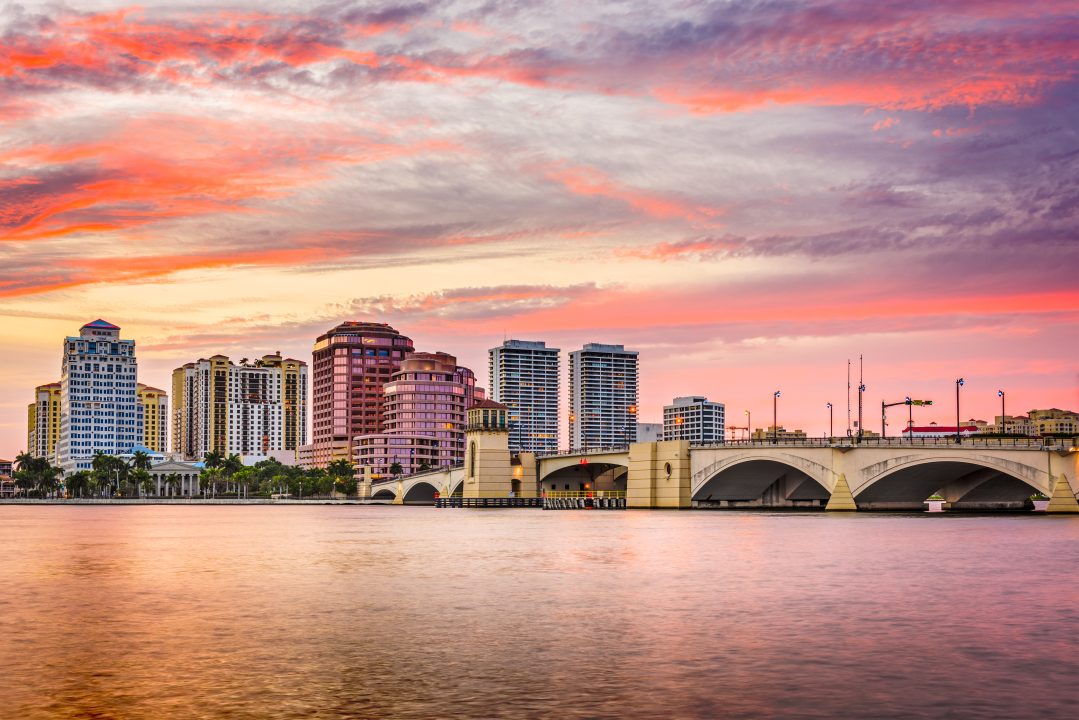 City of West Palm Beach at sunset, with pink hues in the clouds above.